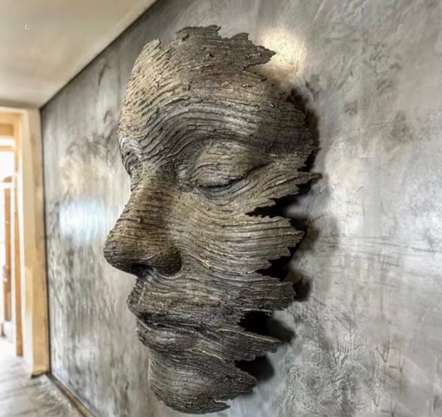 Textured wooden face sculpture wall installation